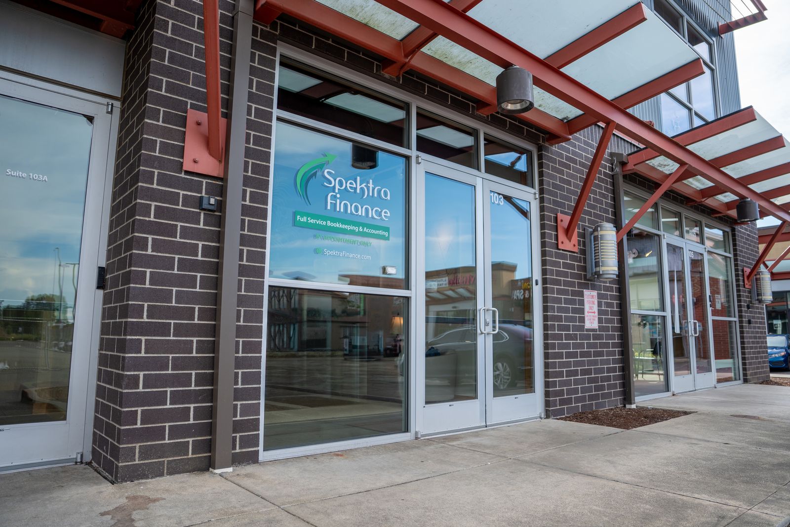 The Spektra Finance entrance in Ferndale: the logo on the glass beside the office door